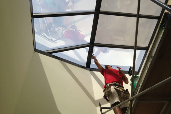 Installing 3M window film on skylights.