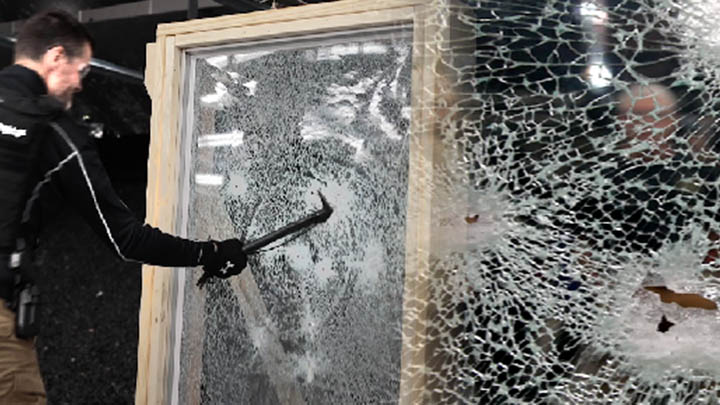 A still image of a man smashing through unprotected glass.